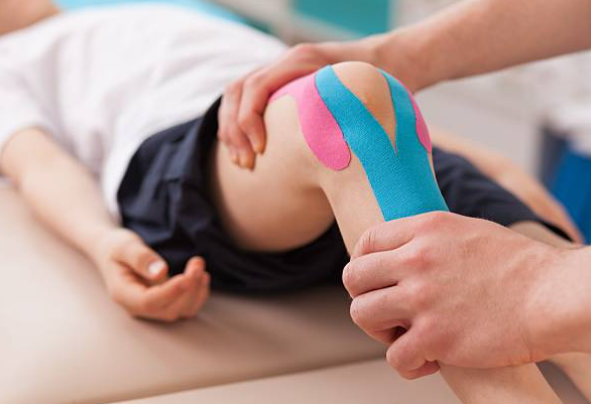 Kinesiology taping for knee support shown on child